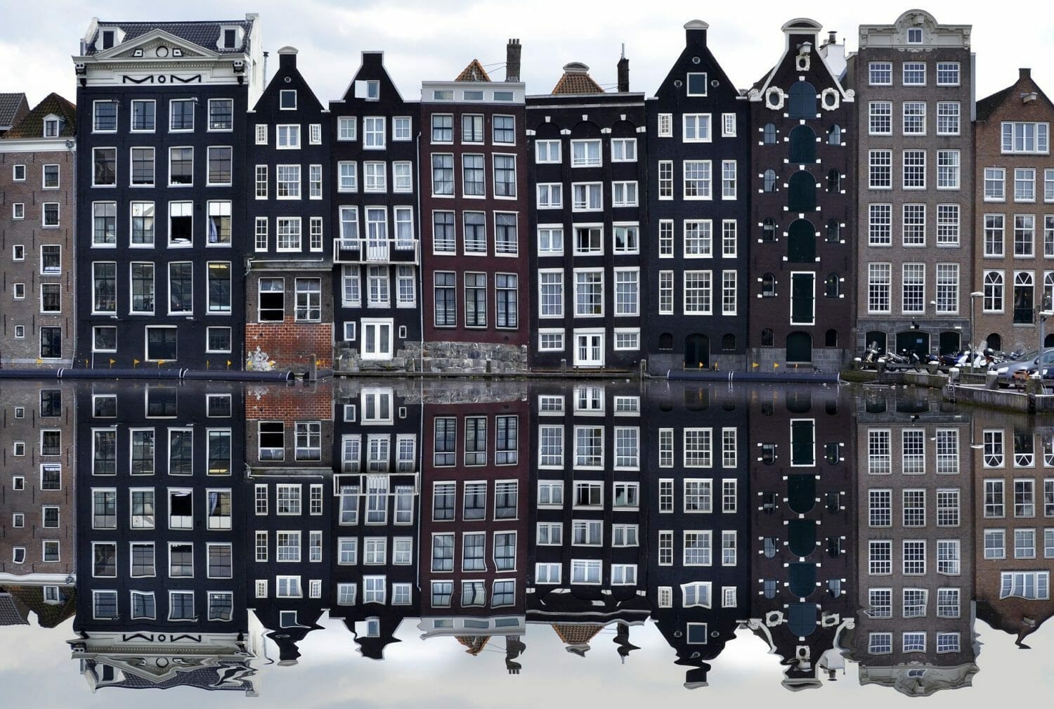 Photo of Dutch buildings in Amsterdam, reflecting in the amsterdam canals.