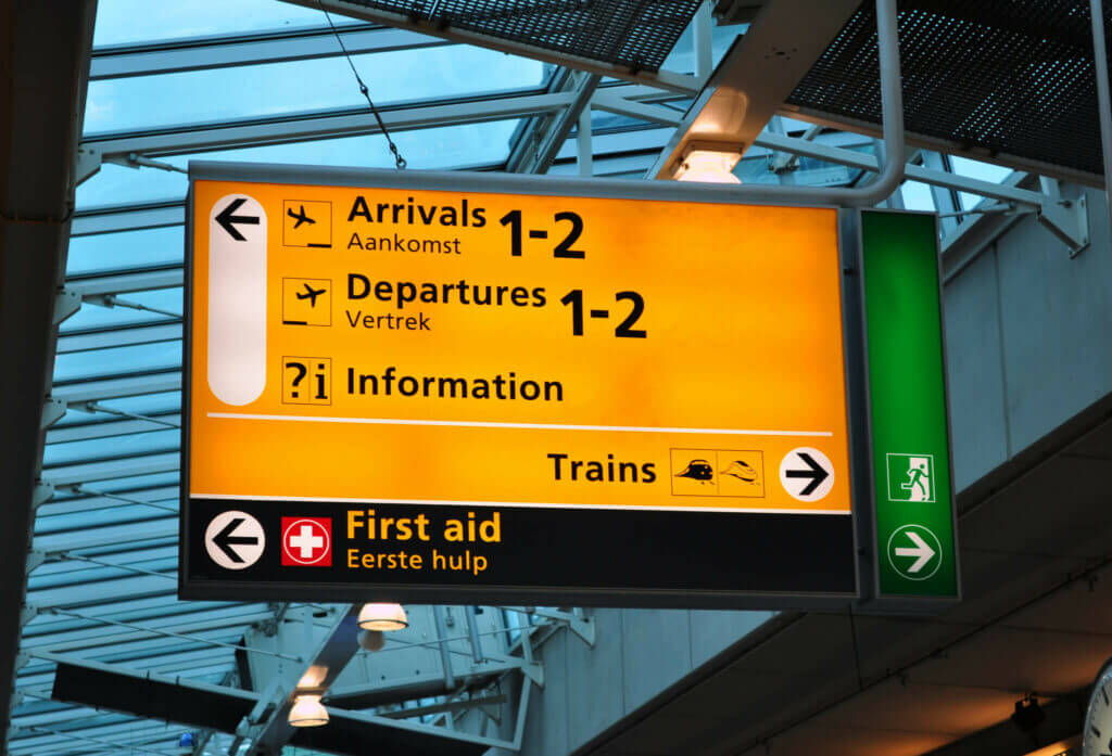 Sign at Schiphol aIrport showing way to arrivals 1-2