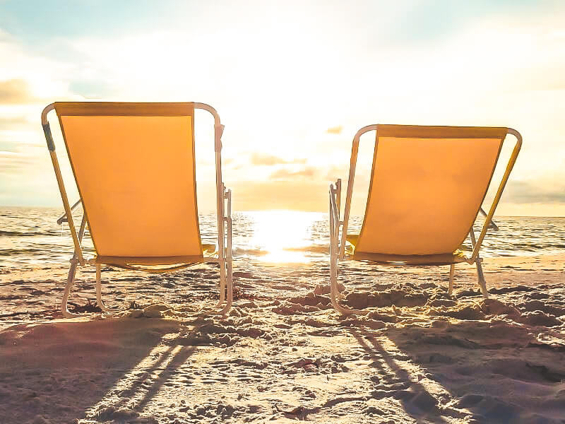 yellow deck chairs on treasure island beach during the sunset