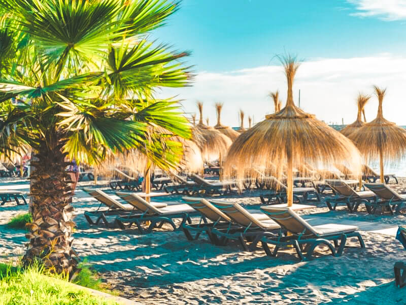 Umbrellas and sun loungers on the beach at Playa de Fanabe in Costa adeje
