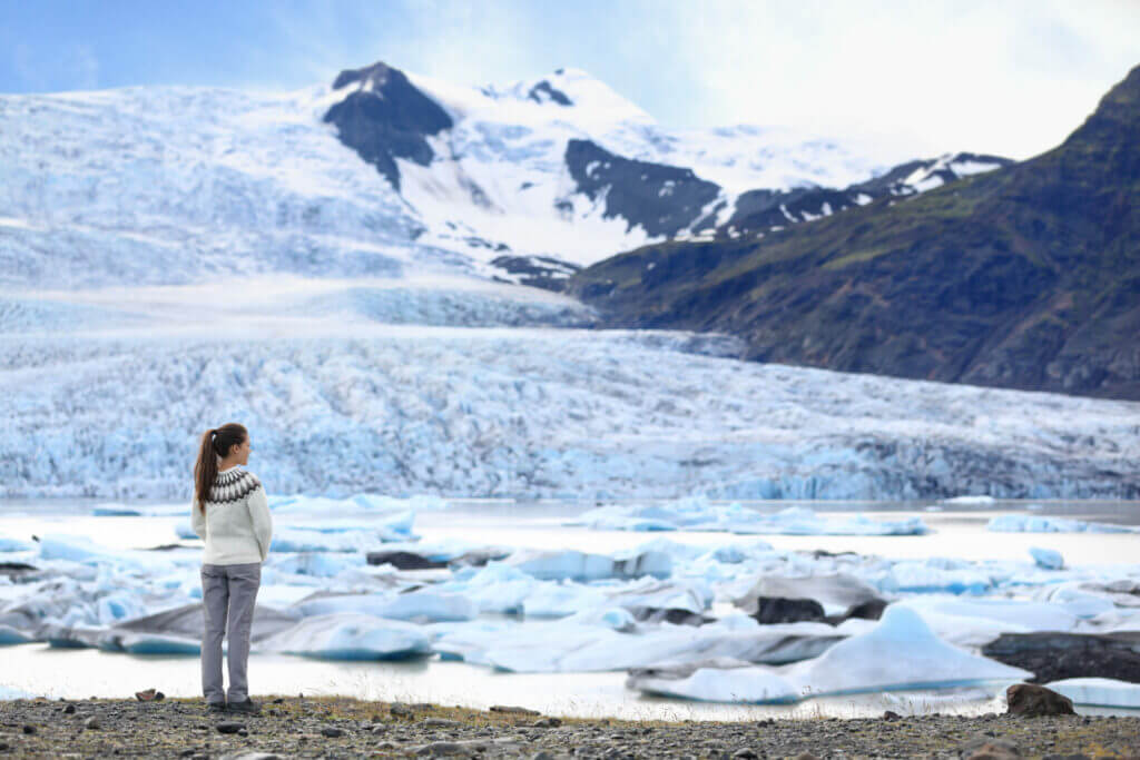 Woman stood by the glacier lagoon in Iceland